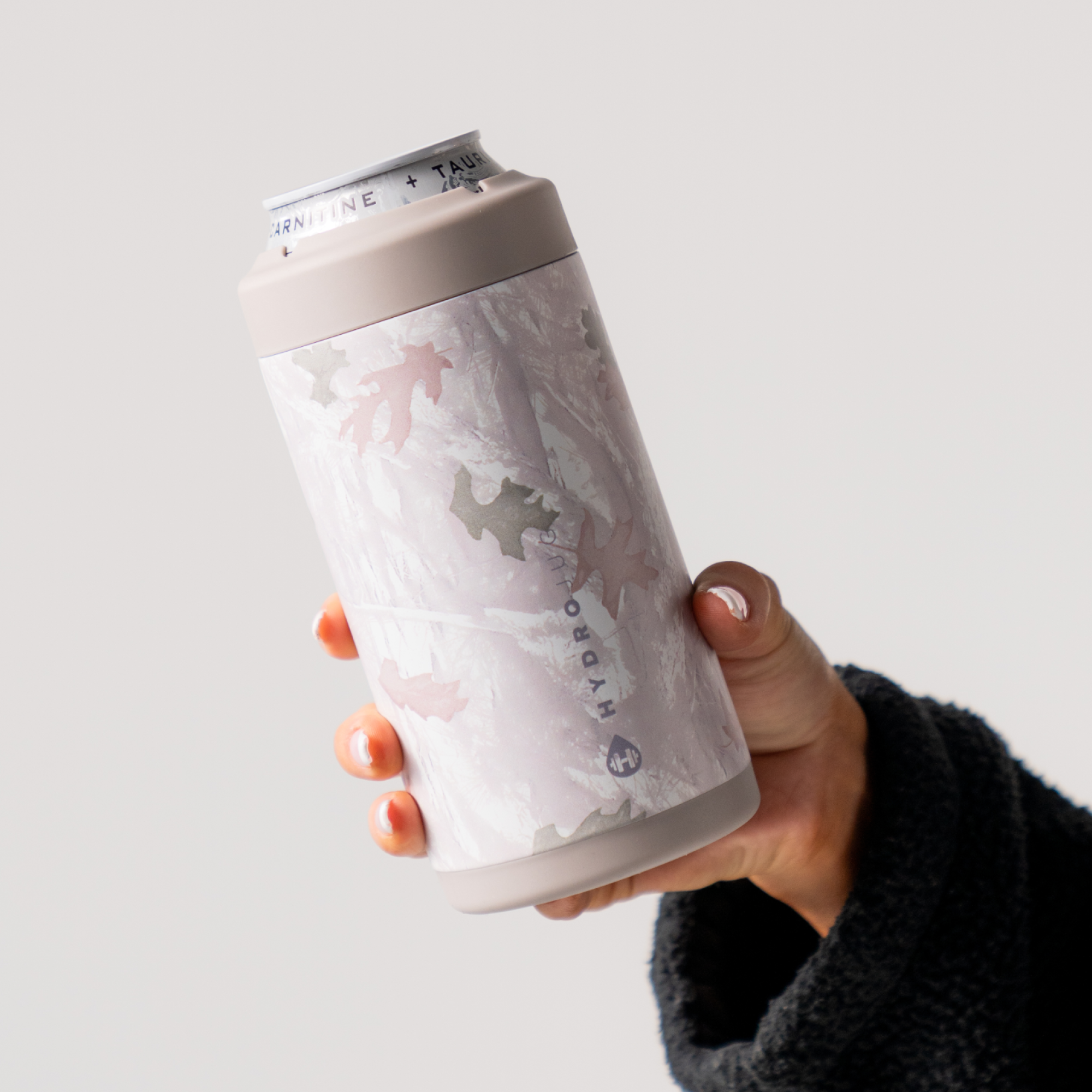 Hands Holding a HydroJug Camo Can Cooler 16oz