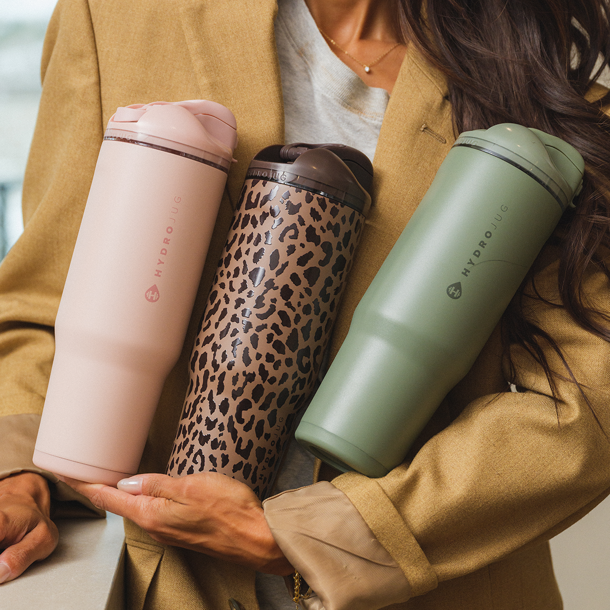 Woman Holding 32oz HydroJug Ease2o in Dusty Rose, Brown Leopard and Courtyard